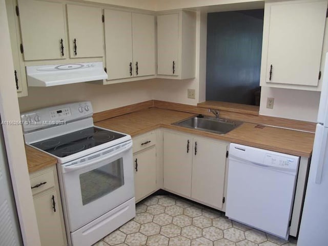 kitchen with sink, ventilation hood, and white appliances