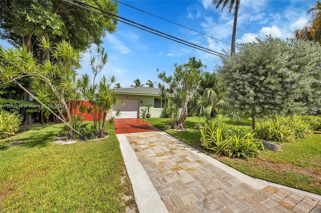 view of front of property featuring a garage and a front yard