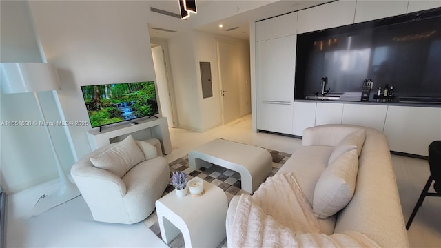 living room featuring electric panel and sink