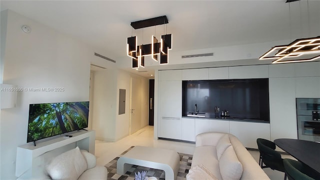 living room with sink, electric panel, and light tile patterned flooring