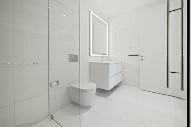 bathroom featuring vanity, toilet, and tile walls