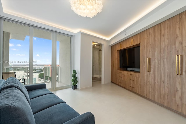 living room featuring wood walls and an inviting chandelier