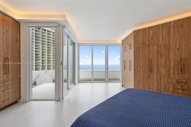 tiled bedroom featuring a water view, expansive windows, access to exterior, and wooden walls