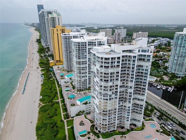 bird's eye view featuring a view of the beach and a water view