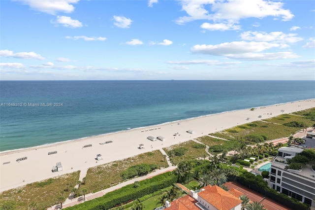 exterior space featuring a water view and a beach view