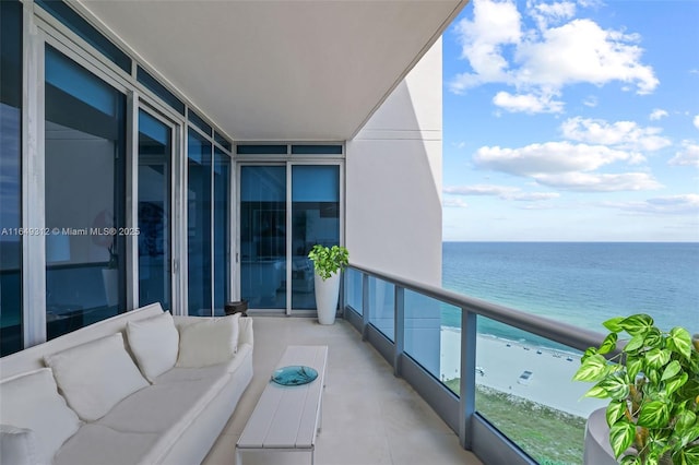 balcony featuring a water view and outdoor lounge area