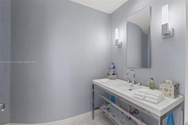 bathroom featuring baseboards and vanity