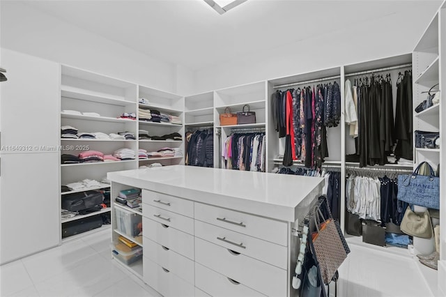 spacious closet with light tile patterned floors