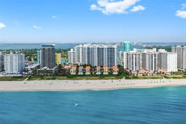 birds eye view of property with a water view, a city view, and a view of the beach