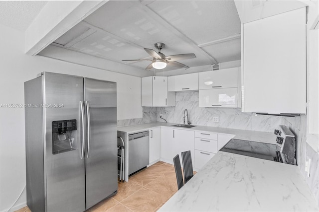 3024 Farnham O Unit 3024, Deerfield Beach, FL 33442 - kitchen featuring appliances with stainless steel finishes, ceiling fan, white cabinets, tasteful backsplash, and light stone counters