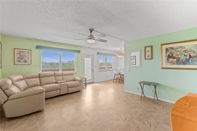 living room featuring a textured ceiling and ceiling fan