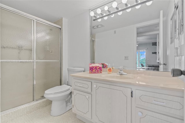 bathroom with vanity, toilet, and an enclosed shower