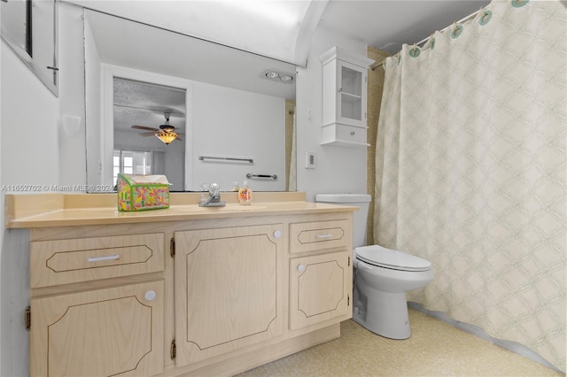 bathroom featuring vanity, toilet, and ceiling fan