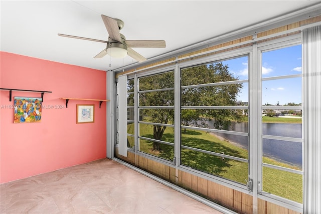 unfurnished sunroom featuring ceiling fan