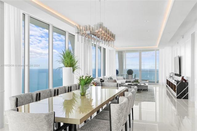 dining space featuring a water view and an inviting chandelier