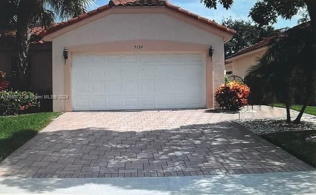 garage featuring decorative driveway