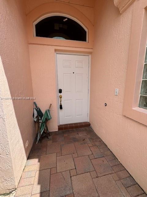 doorway to property with stucco siding