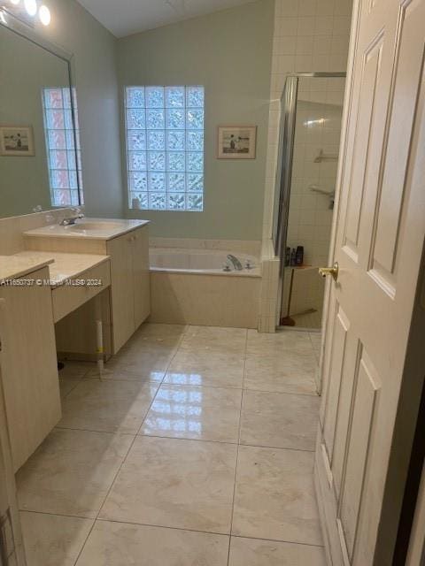 bathroom with a garden tub, a stall shower, vanity, and tile patterned flooring