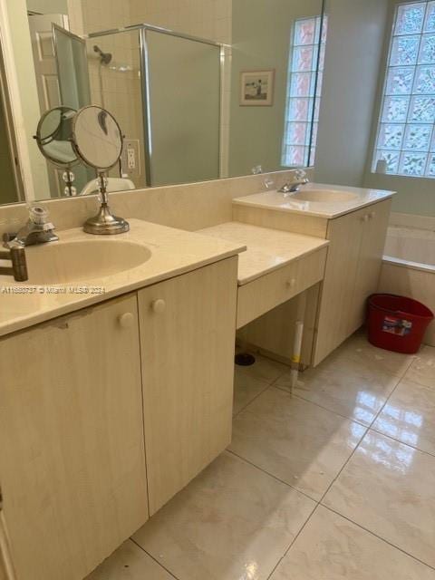 bathroom with tile patterned floors, vanity, a tub, and a shower stall