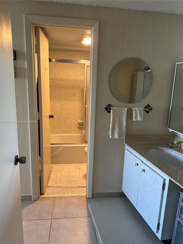 full bathroom with tile patterned flooring, vanity, toilet, and washtub / shower combination