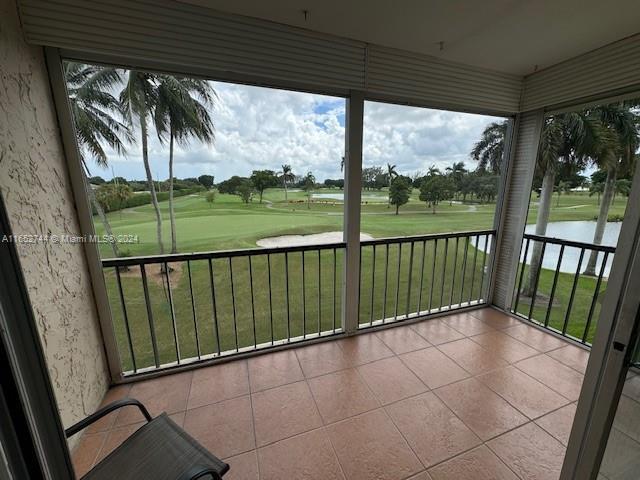 unfurnished sunroom with a water view