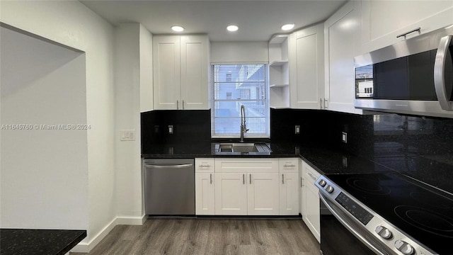 kitchen with sink, white cabinets, stainless steel appliances, and dark hardwood / wood-style floors