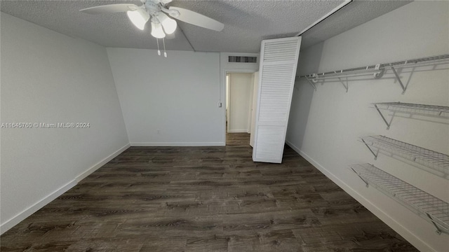 unfurnished bedroom with a closet, dark hardwood / wood-style floors, a textured ceiling, and ceiling fan