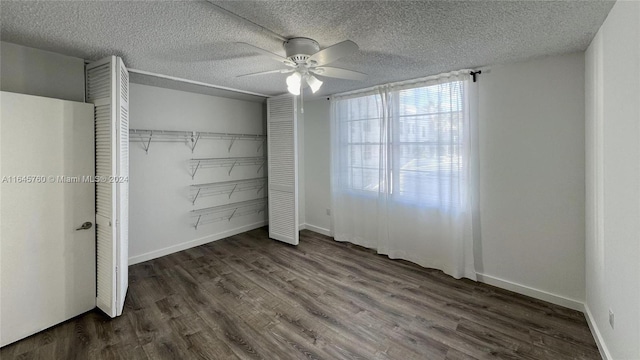 unfurnished bedroom featuring a closet, a textured ceiling, dark wood-type flooring, and ceiling fan