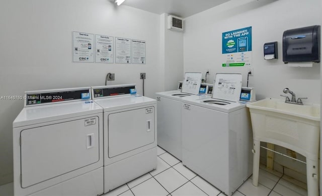 laundry area with light tile patterned floors and separate washer and dryer