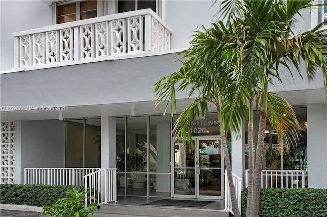 view of exterior entry featuring a balcony