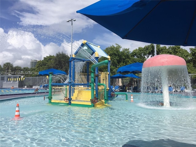 view of pool featuring a playground