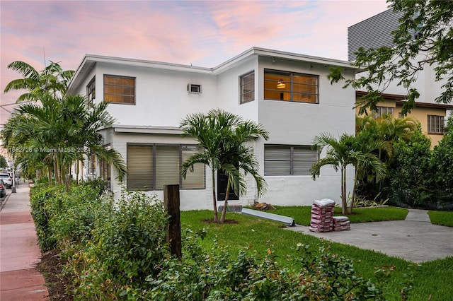 view of front of property featuring a yard and stucco siding