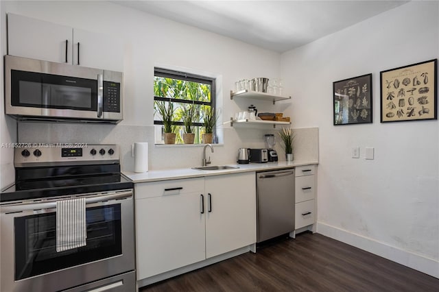 kitchen featuring a sink, backsplash, appliances with stainless steel finishes, and light countertops