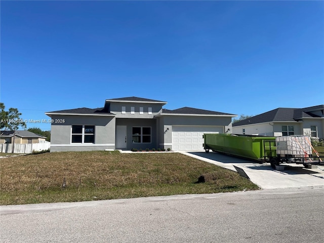 view of front of property with a garage and a front yard