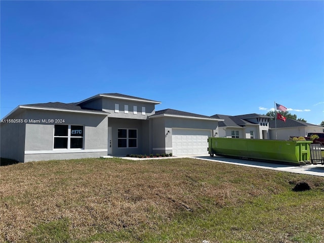 view of front of property with a garage and a front yard