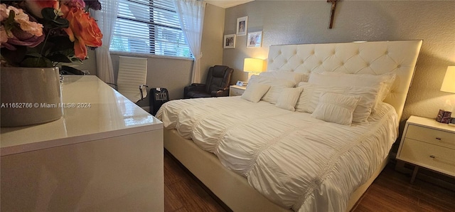 bedroom with dark hardwood / wood-style floors