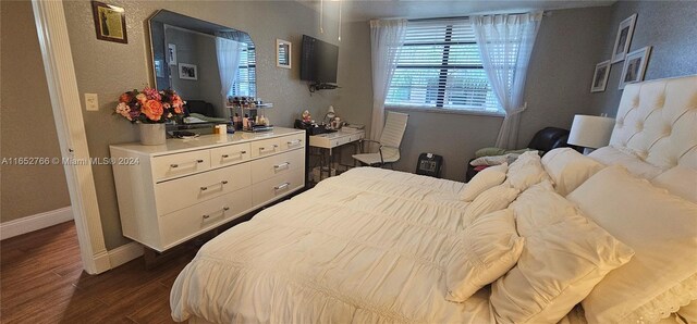 bedroom featuring dark hardwood / wood-style flooring