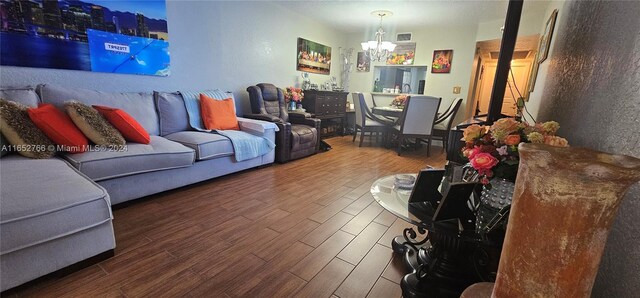 living room with a notable chandelier and wood-type flooring