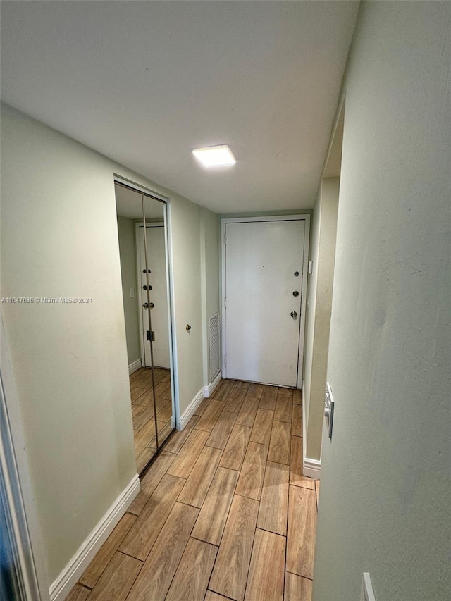 hallway with light hardwood / wood-style flooring