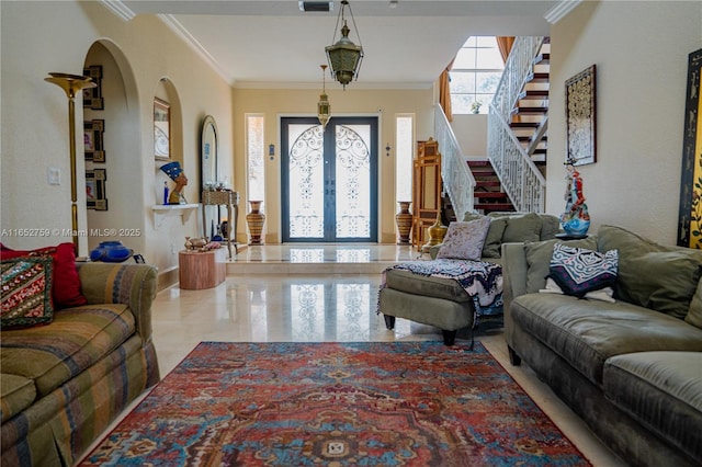 living room with arched walkways, french doors, crown molding, visible vents, and stairway