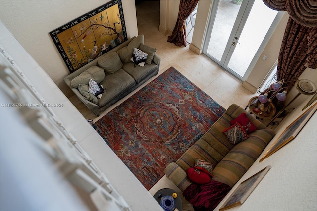 living area featuring french doors and tile patterned flooring