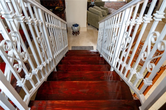 stairs featuring wood finished floors