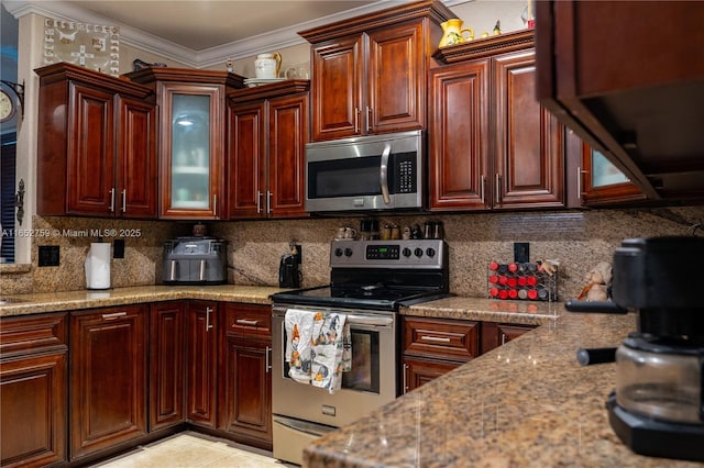 kitchen with appliances with stainless steel finishes, backsplash, light stone counters, and crown molding