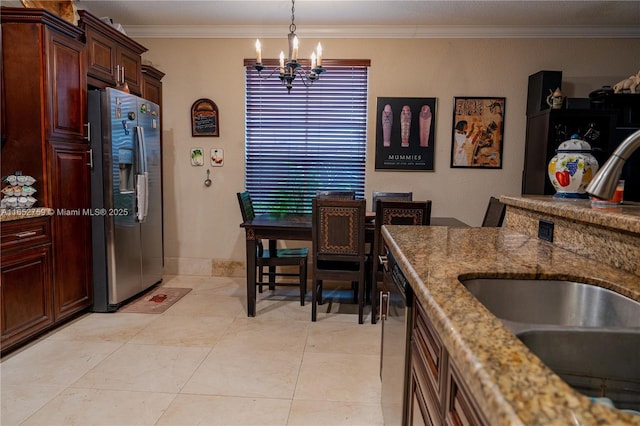 kitchen featuring light stone countertops, crown molding, appliances with stainless steel finishes, and a sink