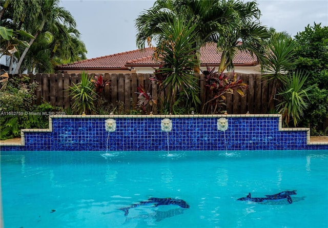 view of swimming pool featuring a fenced in pool and fence