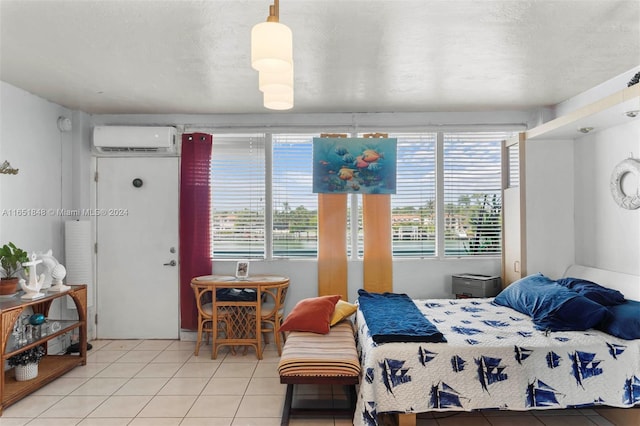 bedroom featuring multiple windows, tile patterned floors, and a wall unit AC