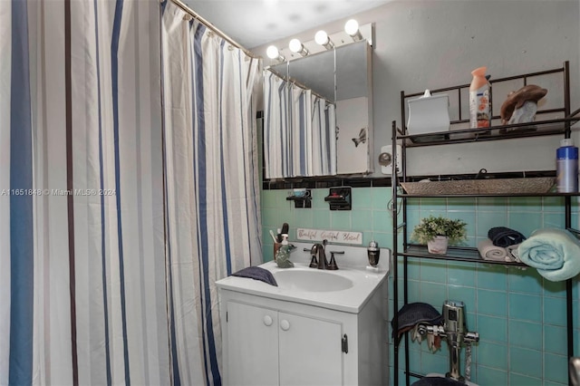 bathroom with vanity, tasteful backsplash, a shower with shower curtain, and tile walls