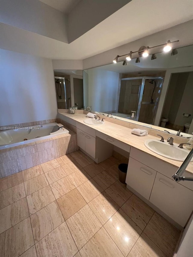 full bathroom with vanity, toilet, tile patterned flooring, and shower with separate bathtub