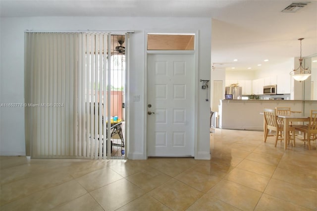 tiled entrance foyer featuring ceiling fan