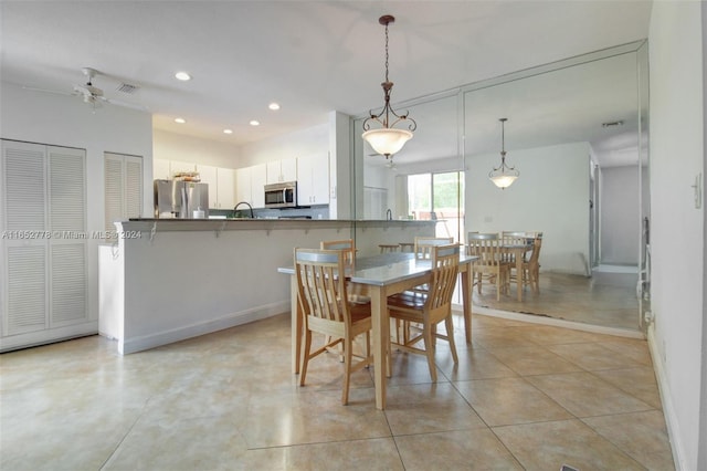 tiled dining area with ceiling fan